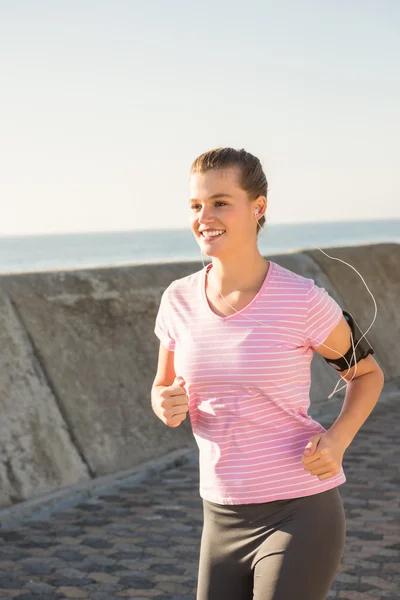 Blonde jogging with headphones — Stock Photo, Image