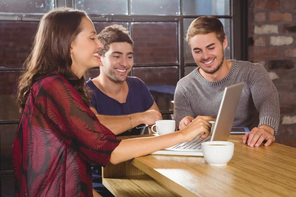 Smiling friends having coffee together