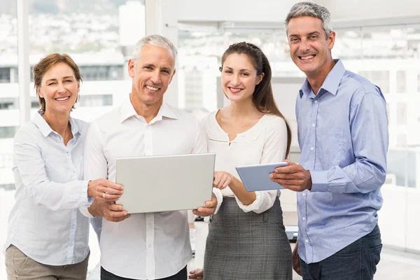 Smiling business people with laptop — Stock Photo, Image