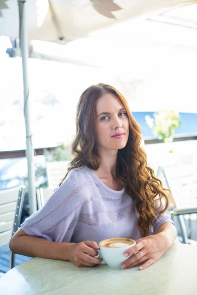 Brunette enjoying a cappuccino — Stock Photo, Image