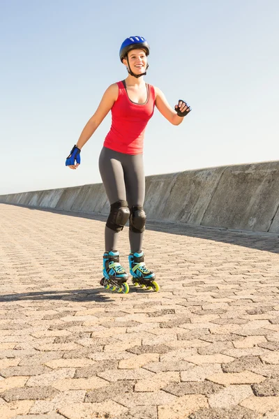 Smiling sporty blonde skating — Stock Photo, Image