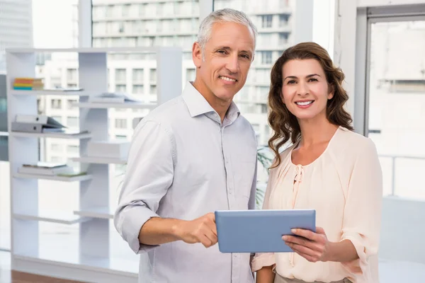Sm casual business colleagues with tablet — Stock Photo, Image