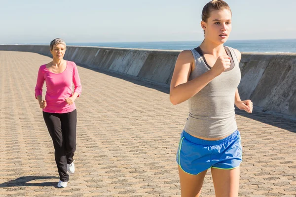 Two sporty women jogging together — Stock Photo, Image