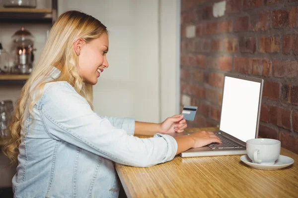 Blonde doing online shopping — Stok fotoğraf