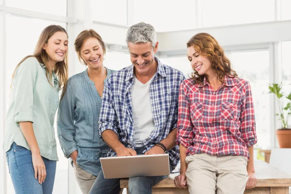 Casual business team having a meeting using laptop — Stock Photo, Image