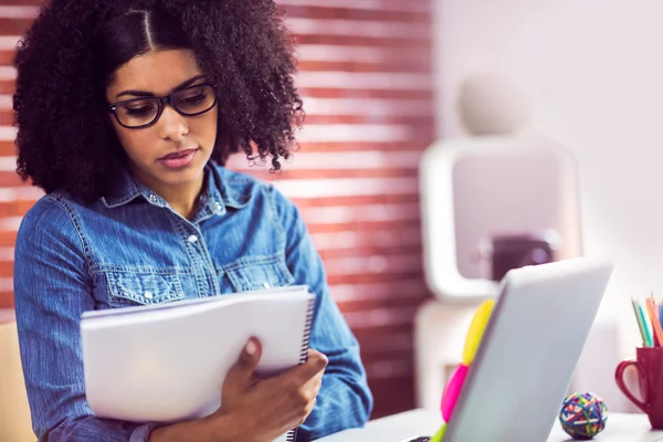 Businesswoman looking at reports — Stock Photo, Image