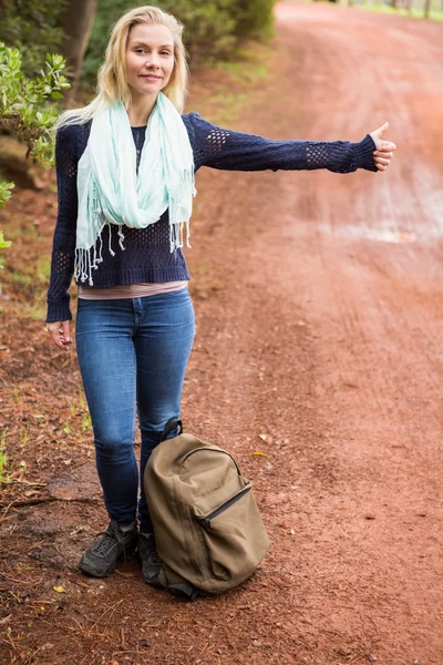 Pretty hitchhiker sticking thumb out — Stock Photo, Image