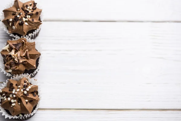 Chocolate cupcakes on a table — Stock Photo, Image