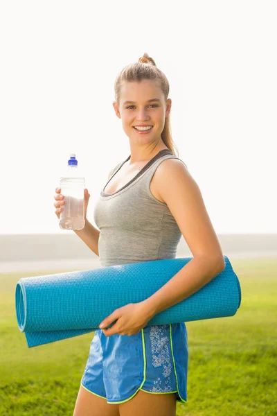 Sportliche Blondine hält Trainingsmatte — Stockfoto