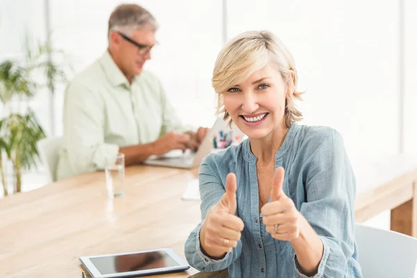 Smiling businesswoman gesturing thumbs up — Stock Photo, Image