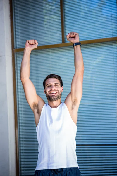 Handsome athlete gesturing victory — Stock Photo, Image