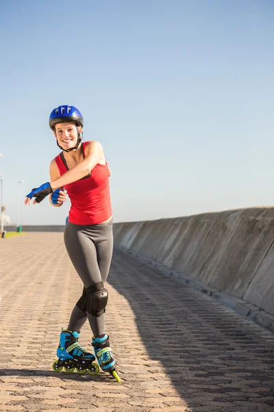 Sporty blonde posing with inline skates — Stock Photo, Image
