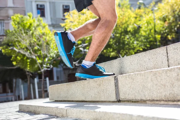 Athlete jogging up the stairs — Stock Photo, Image