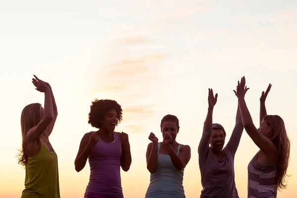 Women cheering against sunset — Stock Photo, Image