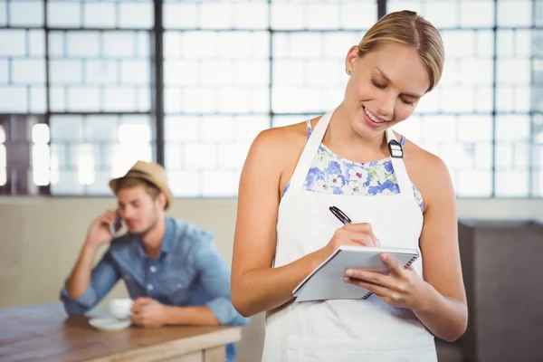 A beautiful waitress taking an order — Stock Photo, Image