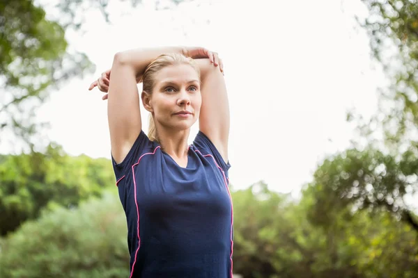 Athletic woman doing arms stretching — Stock Photo, Image