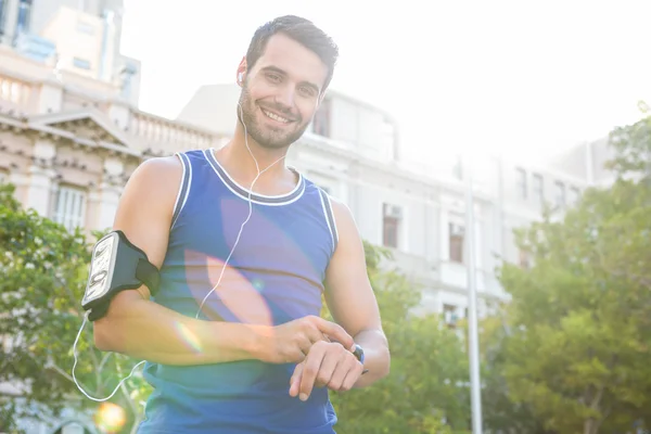 Athlete setting heart rate watch — Stock Photo, Image