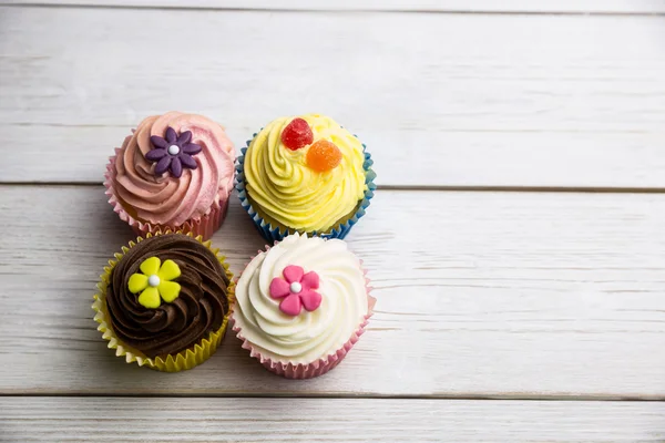 Delicious cupcakes on a table — Stock Photo, Image