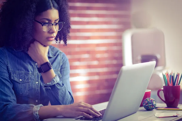 Empresária usando laptop e smartwatch — Fotografia de Stock