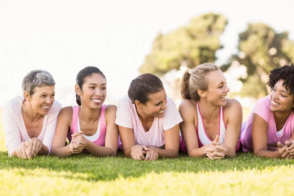 Smiling women lying in a row — Stock Photo, Image