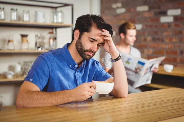 Worried man drinking a coffee — Stock Photo, Image