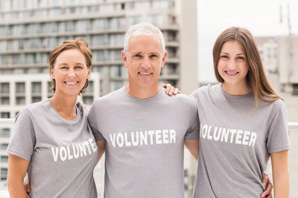 Volunteers putting arms around each other — Stock Photo, Image