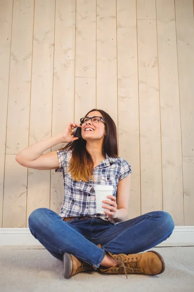 Vacker hipster på telefonen håller cup — Stockfoto