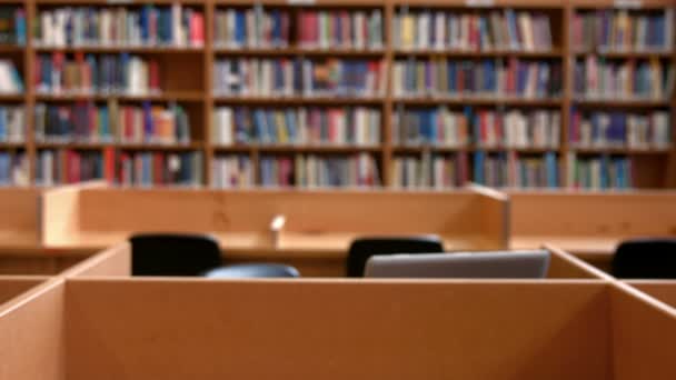 Student working on laptop in the library — Stock Video