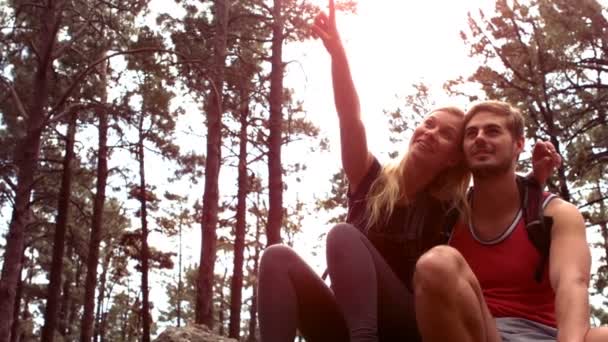 Couple taking a break after hiking uphill — Stock Video