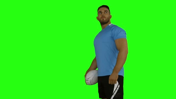 Serious rugby player holding ball — Stock Video