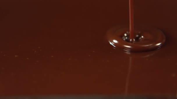 Melted chocolate pouring over almonds — Stock Video