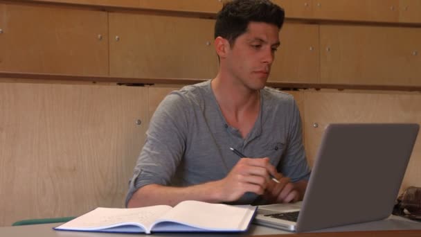 Student macht sich Notizen in Vorlesung — Stockvideo