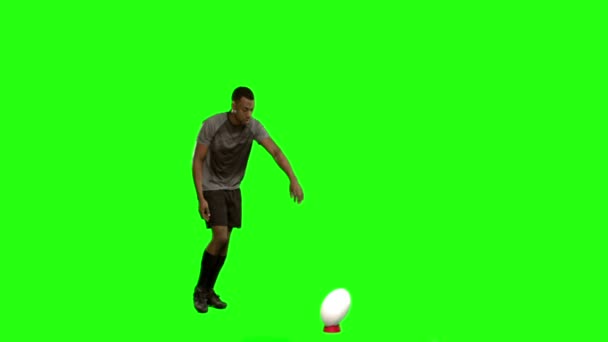 Serious rugby player kicking ball — Stock Video