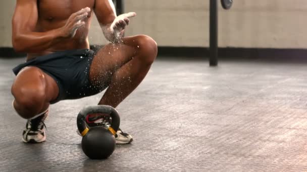 Fit man chalking his hands in gym — Stock Video