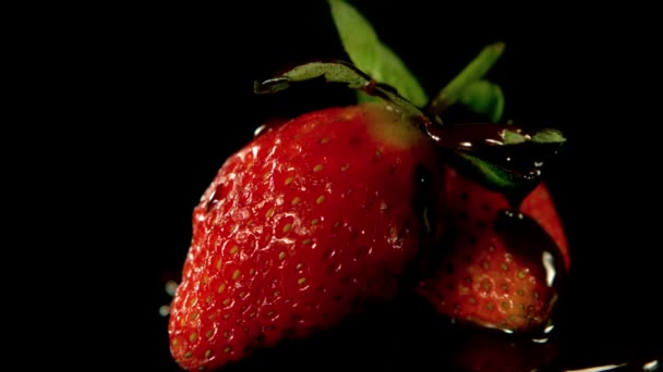 Melted chocolate pouring over strawberry — Stock Video