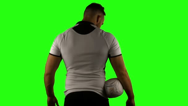 Serious rugby player holding ball — Stock Video