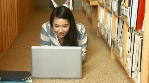 Studente che legge un libro in biblioteca — Video Stock