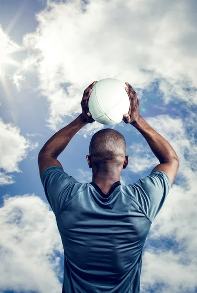 Athlete throwing rugby ball — Stock Photo, Image