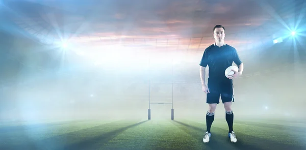 Jogador segurando uma bola de rugby — Fotografia de Stock