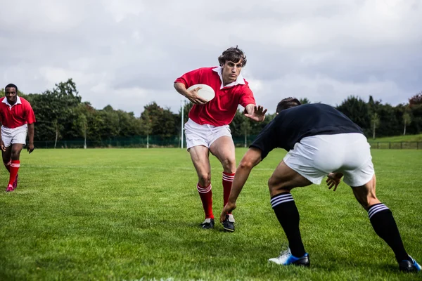 Rugbyspillere som tar tak i spillet – stockfoto