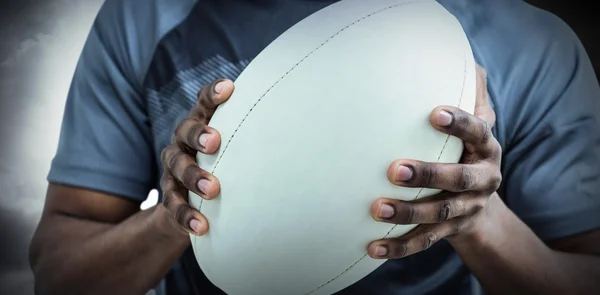 Sportowiec trzyma rugby piłka — Zdjęcie stockowe