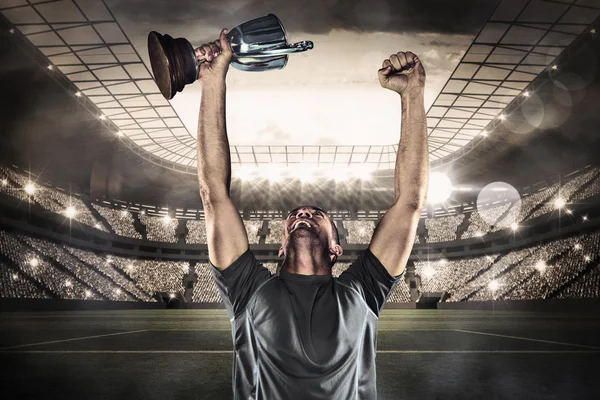 Rugby player holding trophy — Stock Photo, Image