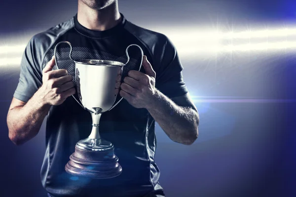 Rugby player holding trophy — Stock Photo, Image