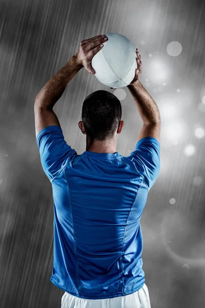 Composite image of rear view of rugby player throwing ball — Stock Photo, Image