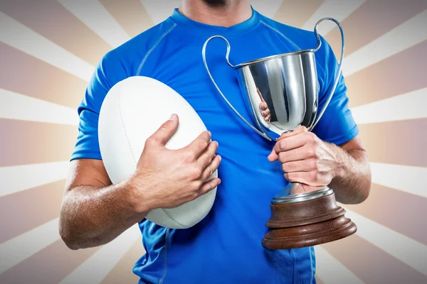 Player holding trophy and ball — Stock Photo, Image