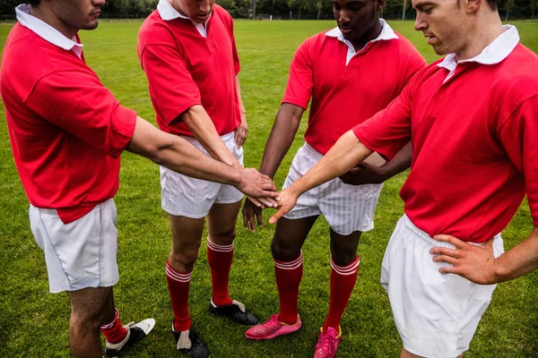 Rugby players putting hands together — Stock Photo, Image