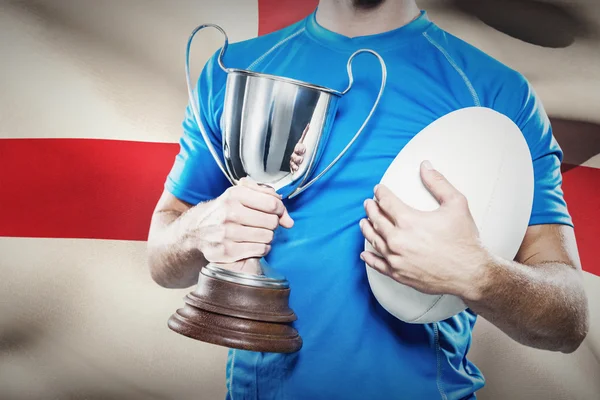 Player holding trophy and ball — Stock Photo, Image