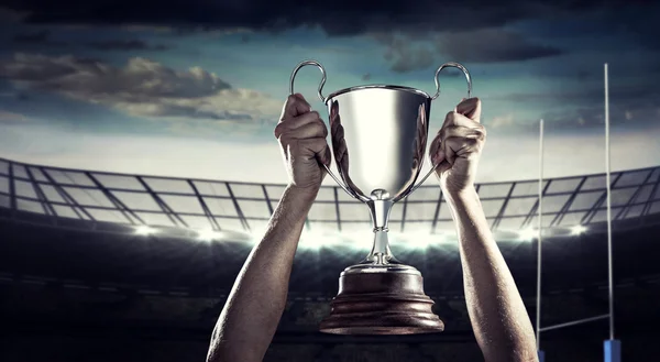 Rugby player holding trophy — Stock Photo, Image