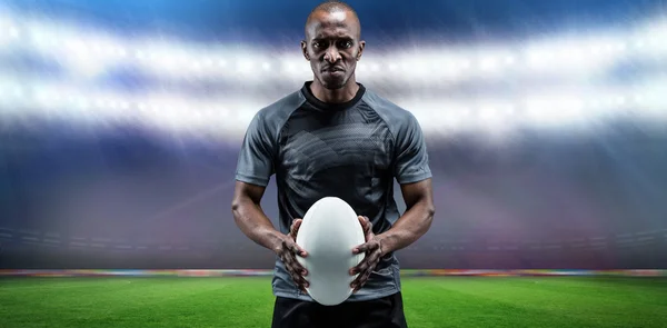 Athlete holding rugby ball — Stock Photo, Image