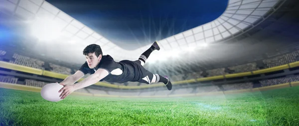 Composite image of a rugby player scoring a try — Stock Photo, Image